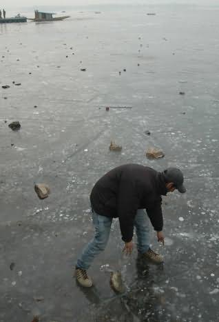 Man Standing On The Frozen Dal Lake In Srinagar