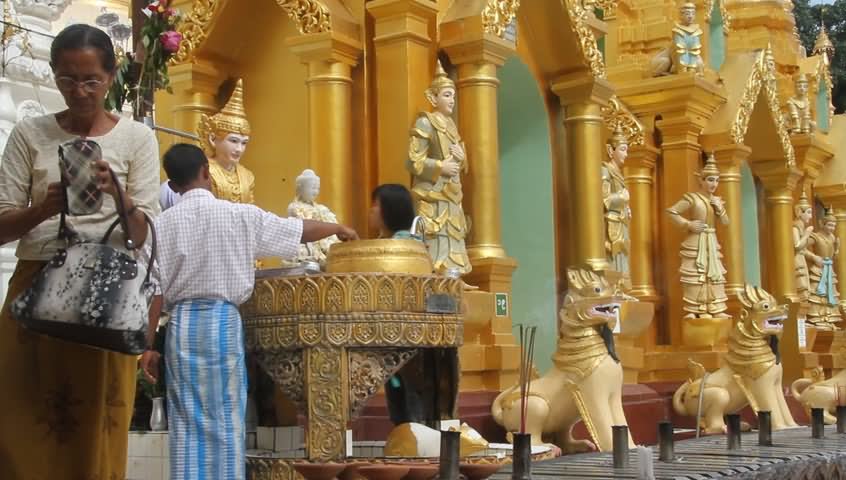 People Wash Buddha Statues Inside The Shwedagon Pagoda