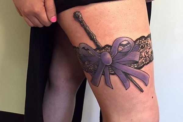 Purple Bow Garter Tattoo On Girl Right Thigh