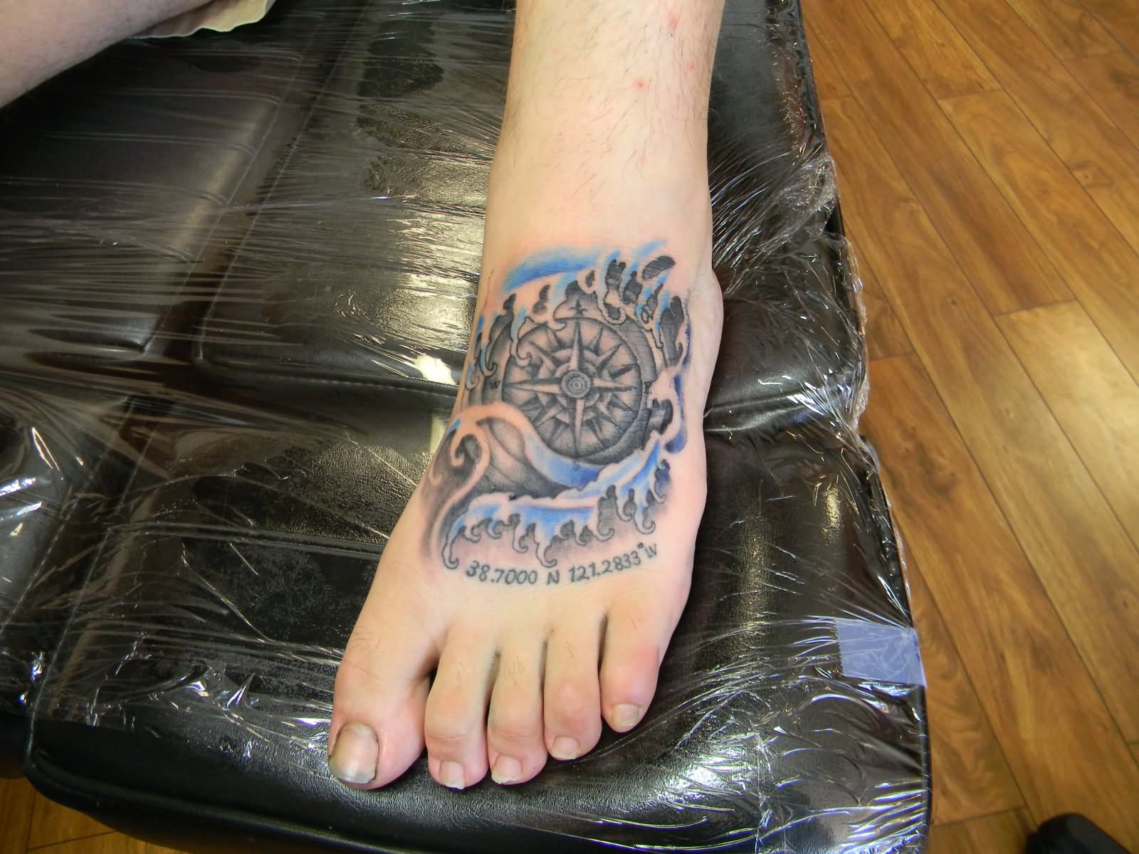 Ripped Skin Compass And Wave Tattoo On Left Foot