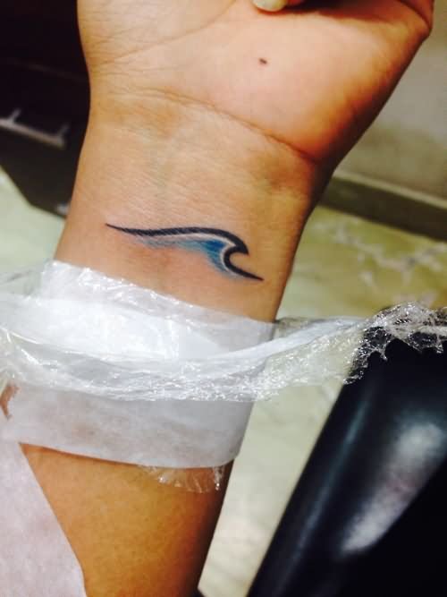 Simple Blue Wave Tattoo On Wrist