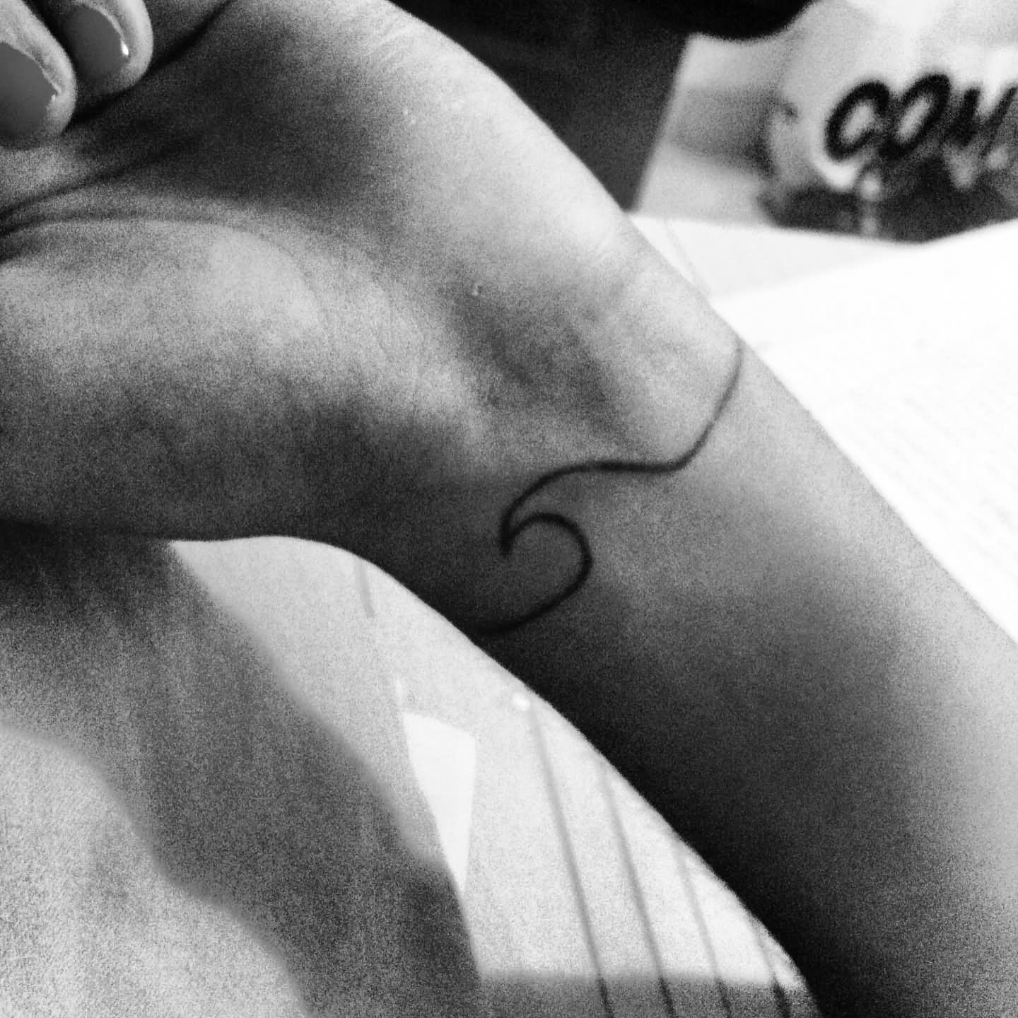 Simple Wave Tattoo On Left Wrist For Girls