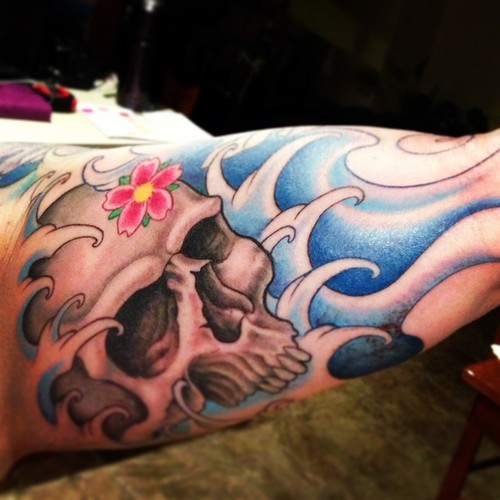 Skull And Wave Tattoo On Inner Bicep