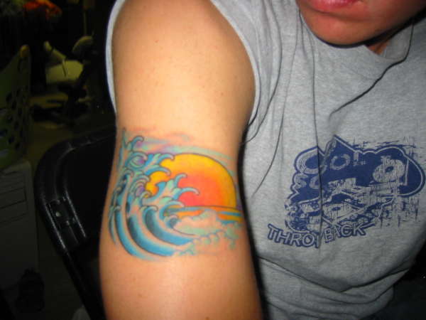 Sun And Wave Tattoo On Right Bicep