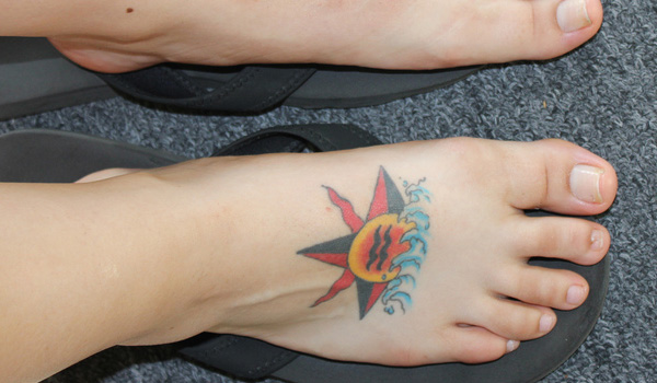 Sun Behind Water Waves Tattoo On Foot