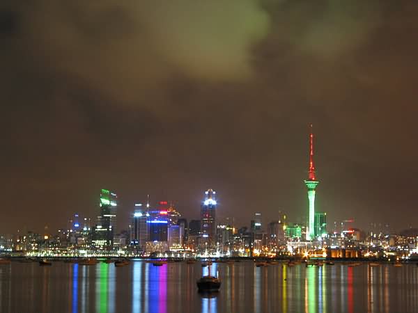 The Sky Tower And Surrounding Buildings In Auckland At Night