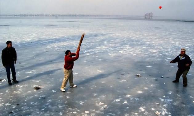 Tourists Enjoying Cricket On The Frozen Dal Lake During Winters