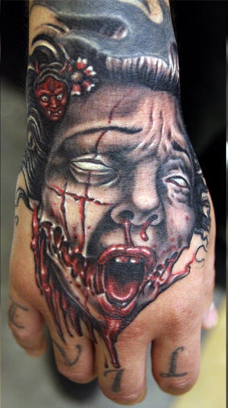 Vampire Face Tattoo On Hand