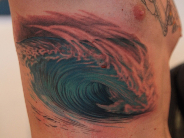 Water Wave Tattoo On Man Side Rib
