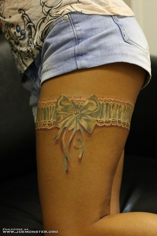 White Ink Bow Flower Garter Tattoo On Thigh