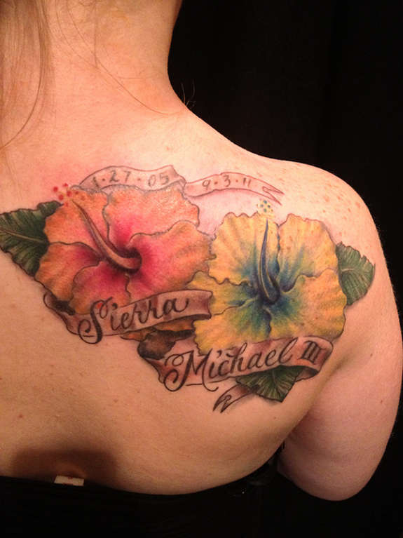 Banner And Hibiscus Tattoos On Right Back Shoulder