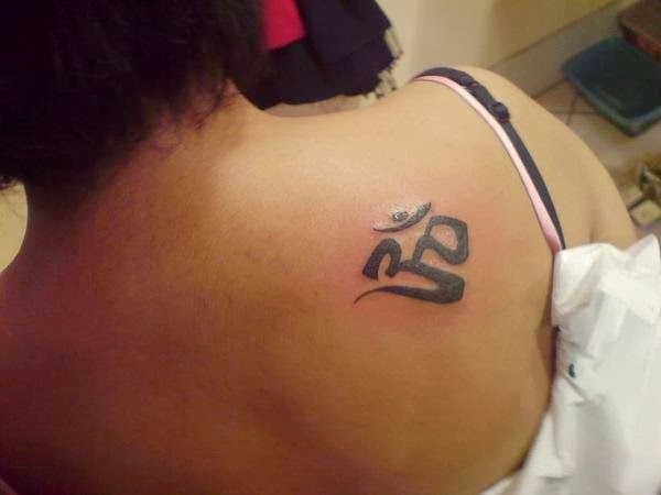 Black Om Symbol Tattoo On Women Right Back Shoulder