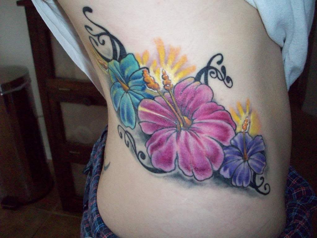 Colored Tribal Hibiscus Tattoos On Side Rib