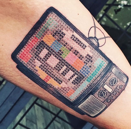 Colorful Cross Stitch Television Tattoo Design For Arm