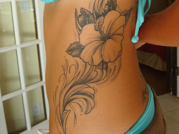 Grey Ink Hibiscus Tattoo On Girl Rib Side