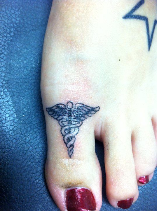 Medical Symbol Tattoo On Girl Toe