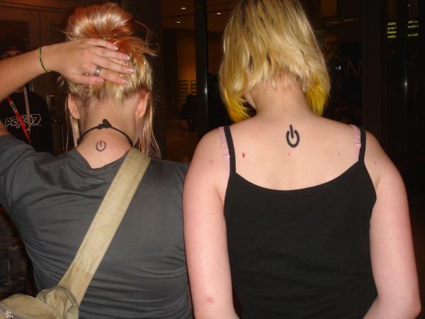 Power Symbol Tattoo On Women Upper Back