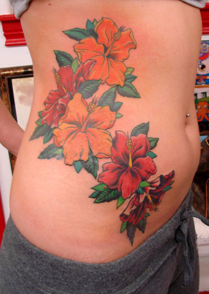 Red And Yellow Hibiscus Tattoo On Side Rib