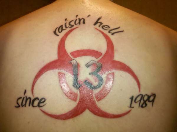 Red Biohazard Symbol Tattoo On Upper Back