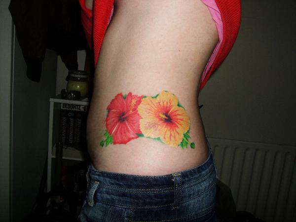 Yellow And Red Hibiscus Tattoo On Side Rib