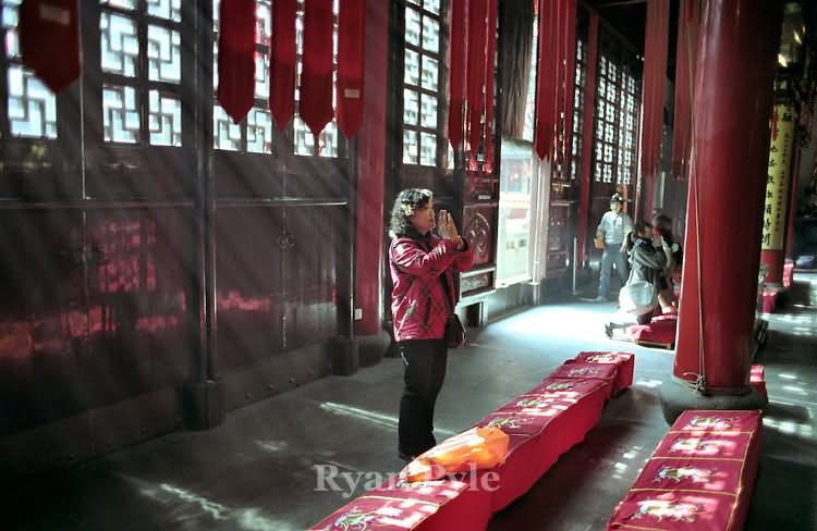 A Woman Prays Inside The Jade Buddha Temple In Shanghai