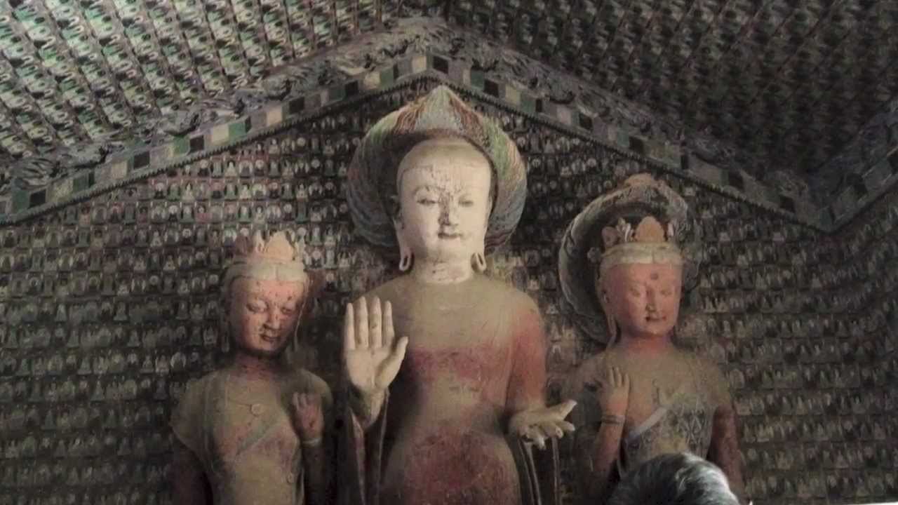 Adorable Lord Buddha Statue Inside Mogao Caves In Dunhuang, China
