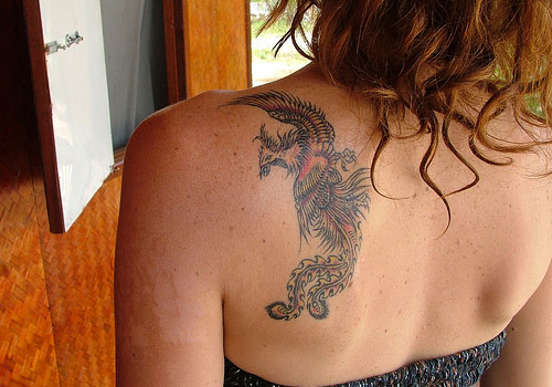 Amazing Phoenix Tattoo On Girl Upper Side Back