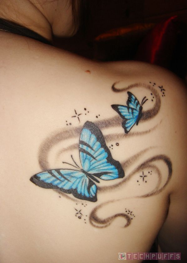 Black And Blue Butterflies Tattoo On Upper Side Back