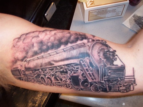 Black And Grey Freight Train Tattoo Design For Bicep