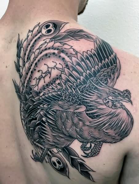 Black And Grey Rising Phoenix From The Ashes Tattoo On Man Right Back Shoulder