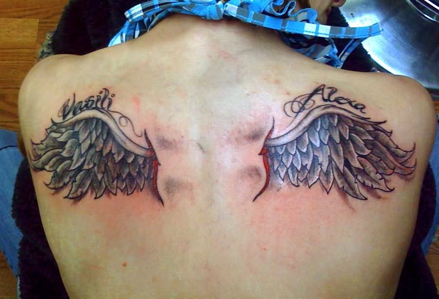 Black And Grey Wings Tattoo On Upper Back