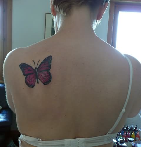 Black And Pink Butterfly Tattoo On Girl Upper Side Back