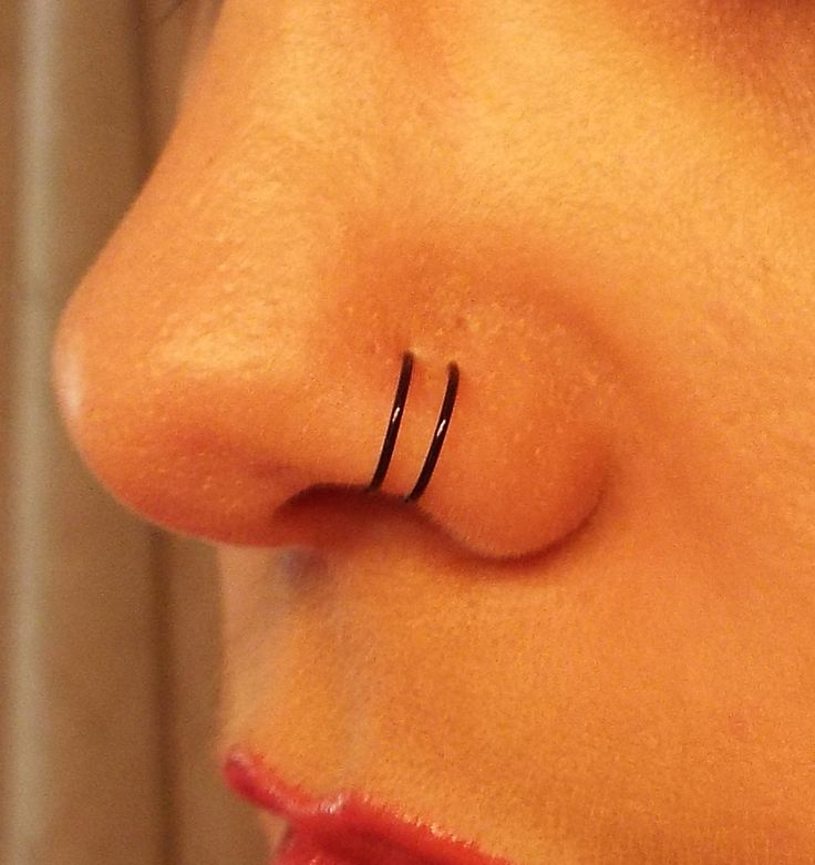 Black Hoop Rings Double Nose Piercing Closeup Image