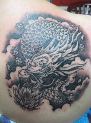 Black Ink Dragon Tattoo On Upper Right Back