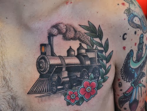 Black Ink Steam Train With Flowers Tattoo On Man Chest