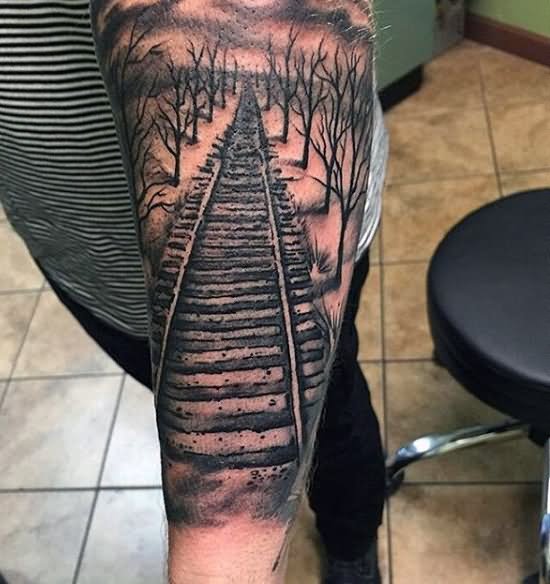 Black Ink Train Tracks With Trees Without Leaves Tattoo Design For Sleeve