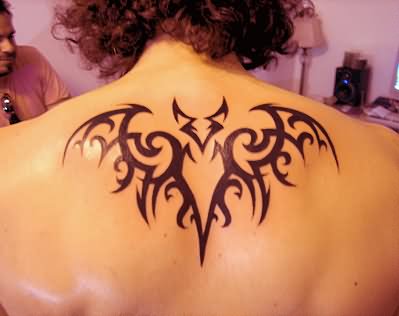 Black Tribal Bat Tattoo On Man Upper Back