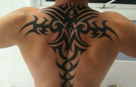 Black Tribal Design Tattoo On Upper Back