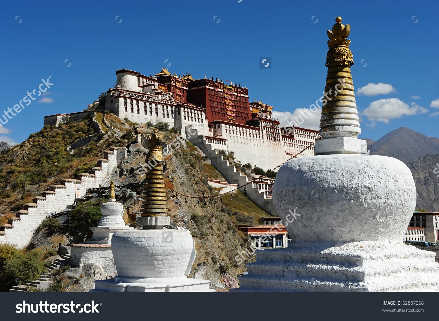 Buddhist Stupa And Potala Palace In Tibet
