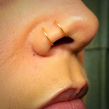Double Nose Piercings With Gold Rings