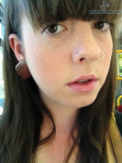 Double Nose Piercings With Stud And Hoop Ring