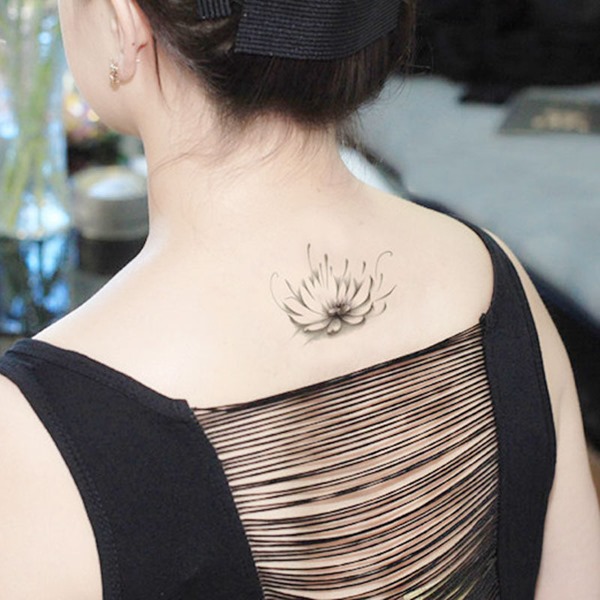 Grey Ink Little Flower Tattoo On Girl Upper Back