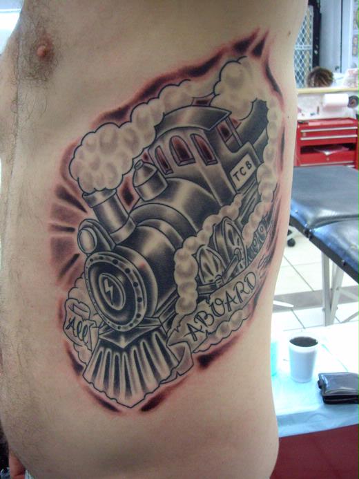 Grey Ink Steam Train With Banner Tattoo On Man Side Rib