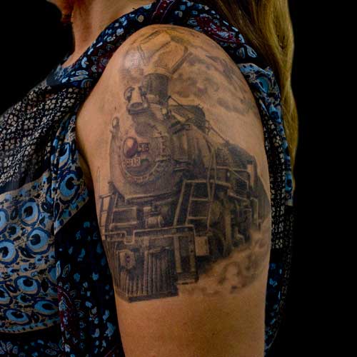 Grey Ink Train Tattoo On Left Shoulder