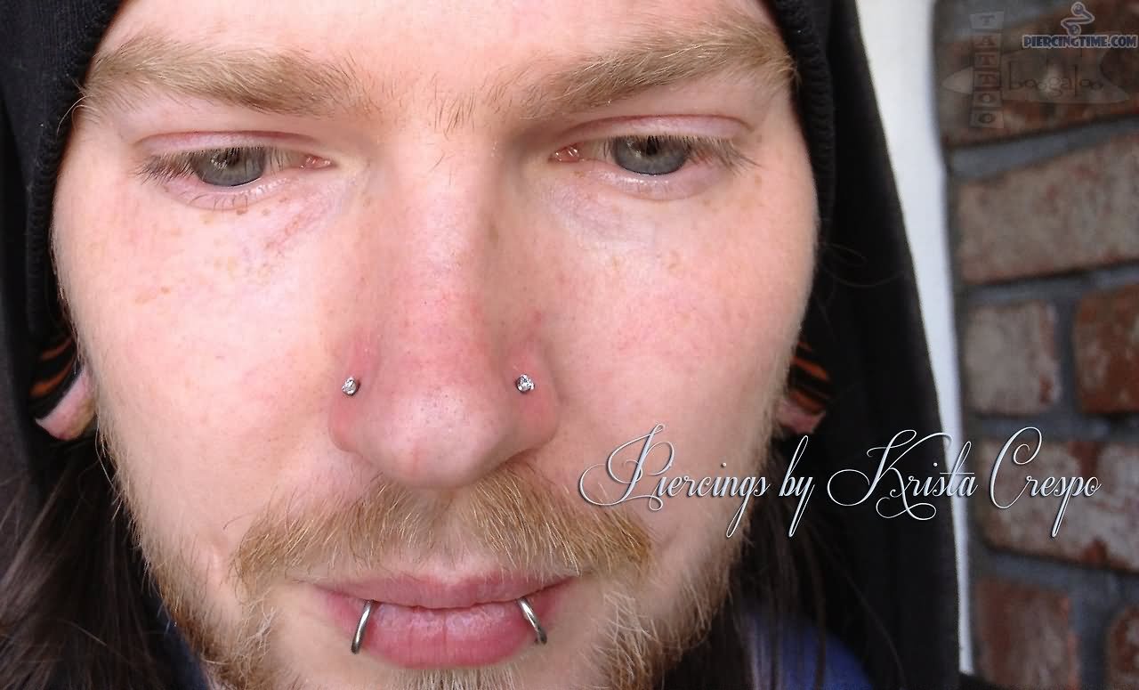 Guy With Snake Bites And Double Nose Piercing