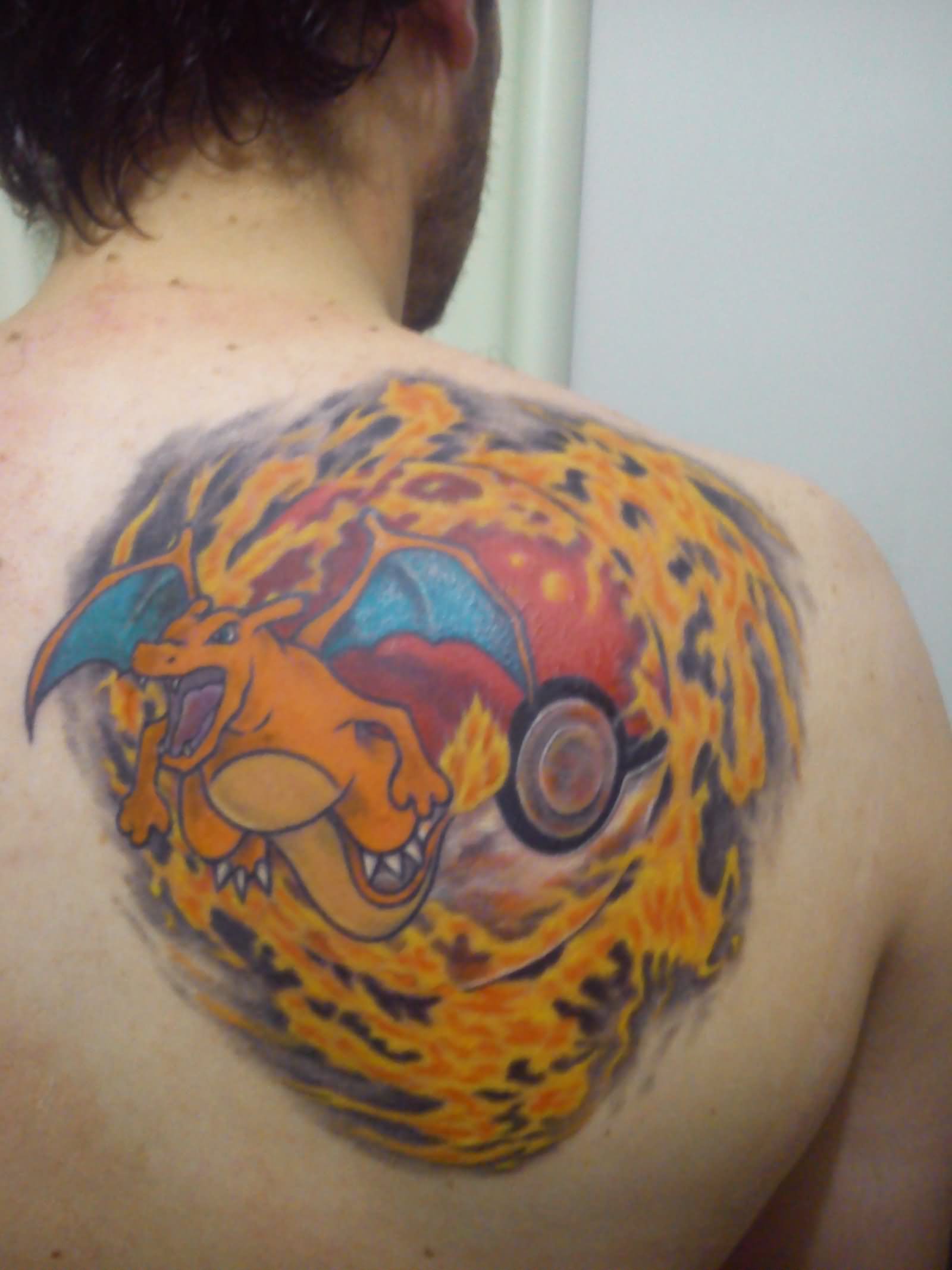 Legendary Charizard Pokemon Tattoo On Man Right Back Shoulder