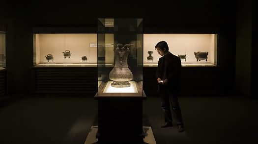 Man Looks At A Wine Vessel On Display Inside The Shanghai Museum