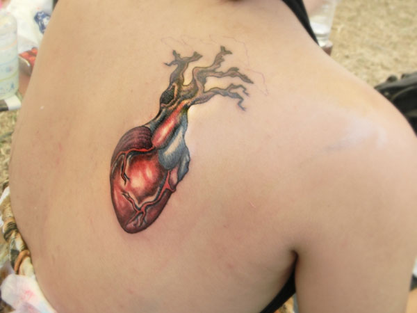 Real Heart Tattoo On Upper Right Back