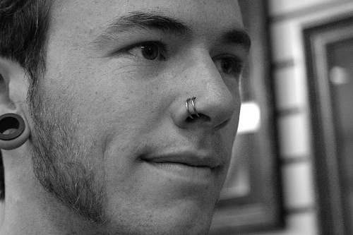 Right Ear Lobe And Double Nose Piercing