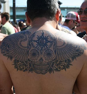 Sugar Skull With Wings Tattoo On Man Upper Back